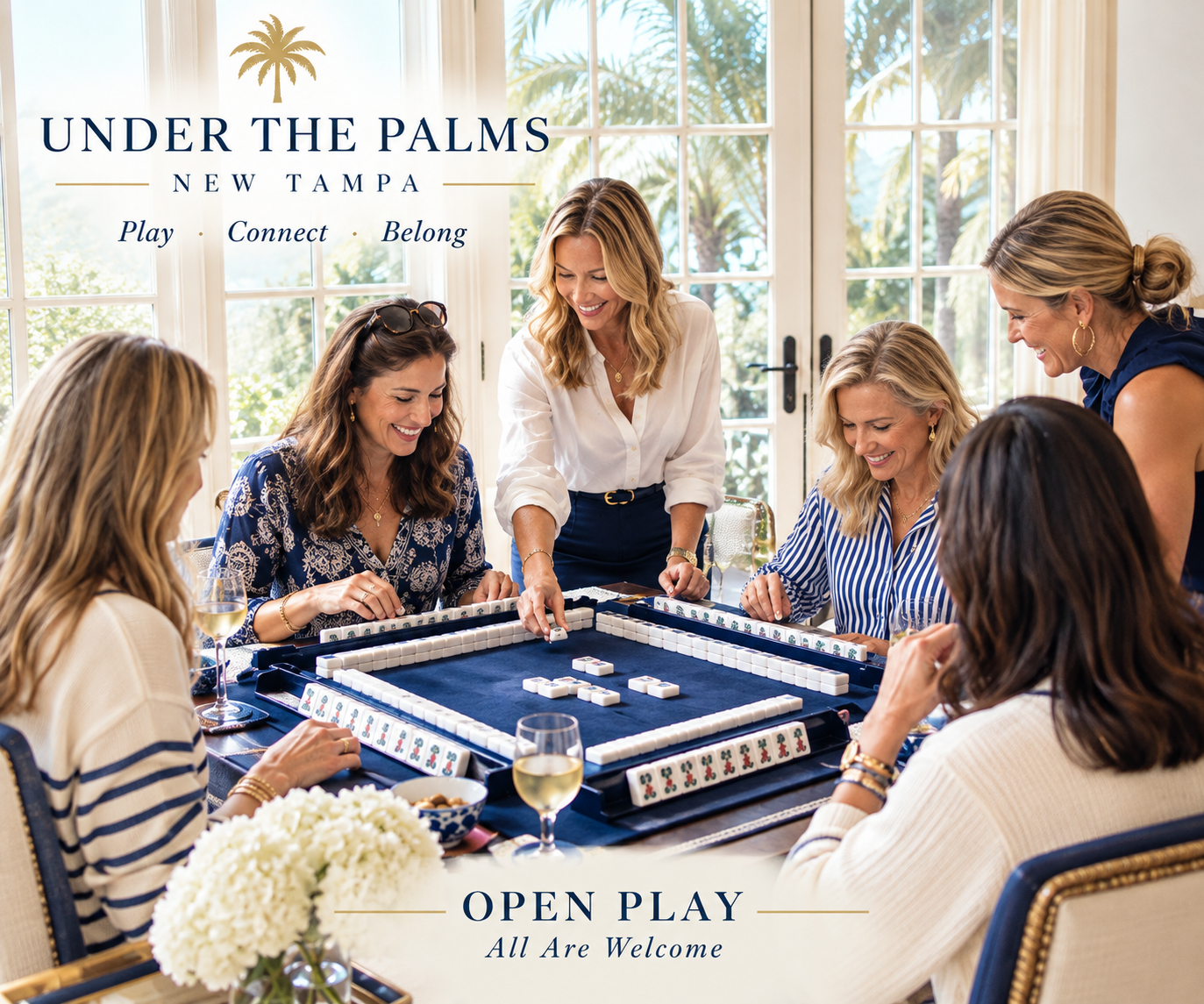 Under the Palms New Tampa — Play, Connect, Belong. Friends gathered around a Mahjong table. Open Play: All Are Welcome.